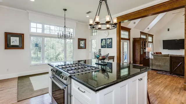 Custom kitchen island with seating overhang and panel-end cabinetry in a Lexington home